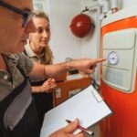 plumber inspecting boiler